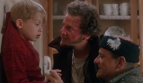 Kevin looking up at the two burglars in a still from Home Alone